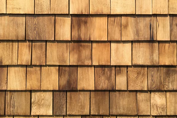 A background of newly roof installed wooden cedar shingles.